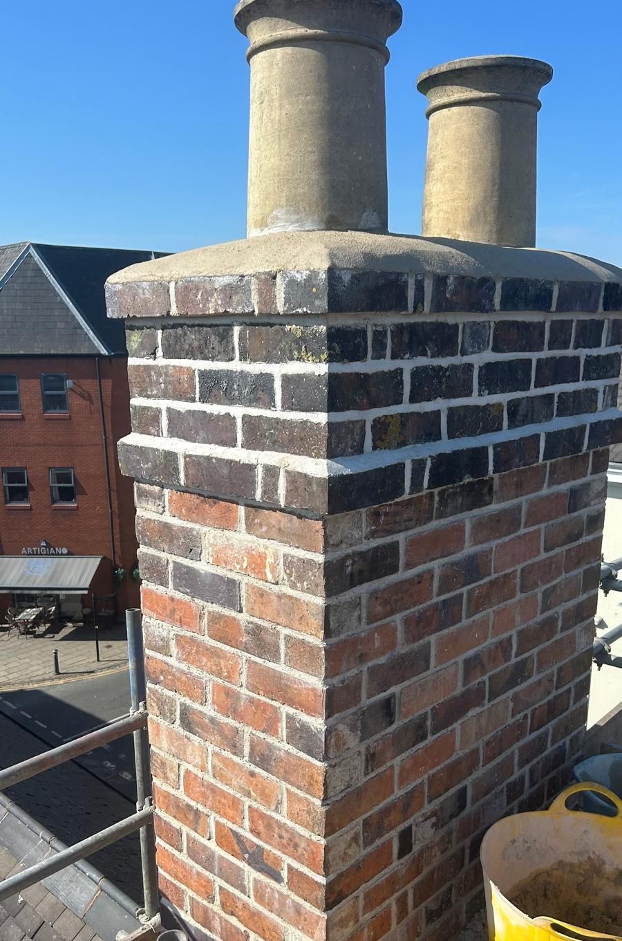 Rebuilt chimney stack with oversailing courses, new flaunching and pots