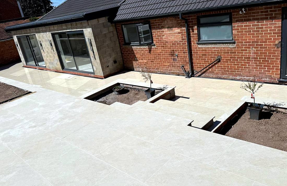 Single-storey rear extension with sliding doors, porcelain patio and raised planters