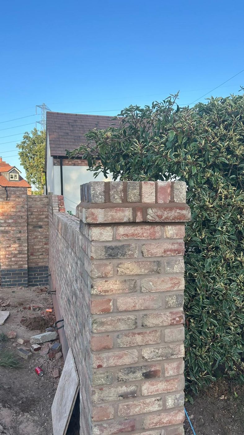 Reclaimed brick pier finished with a brick-on-edge cap