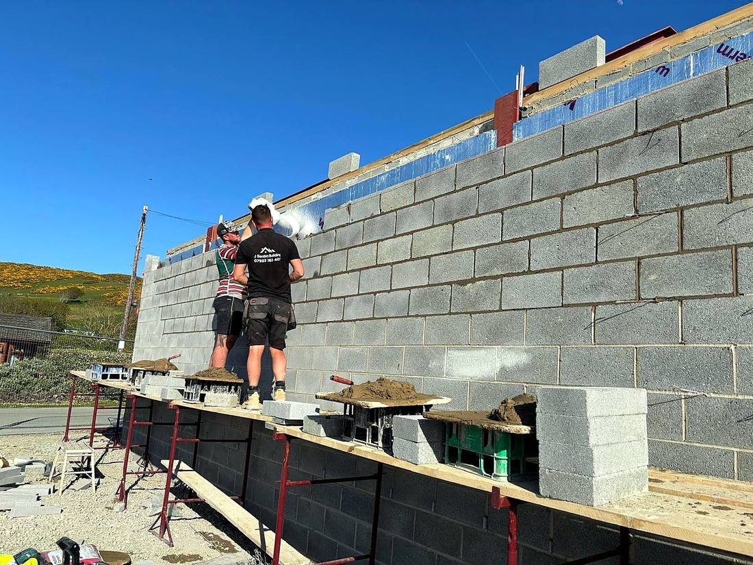 Working on the scaffold of a blockwork extension