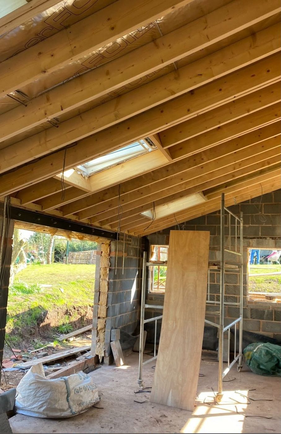 Vaulted extension roof with exposed timbers, rooflights and a steel beam over the opening